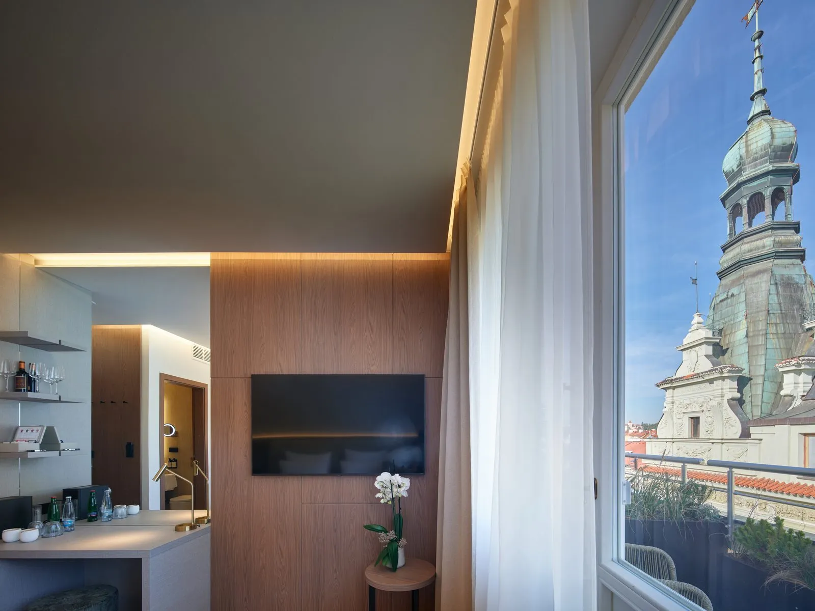 Guest room with a view of the church tower – The Benedict Boutique Hotel